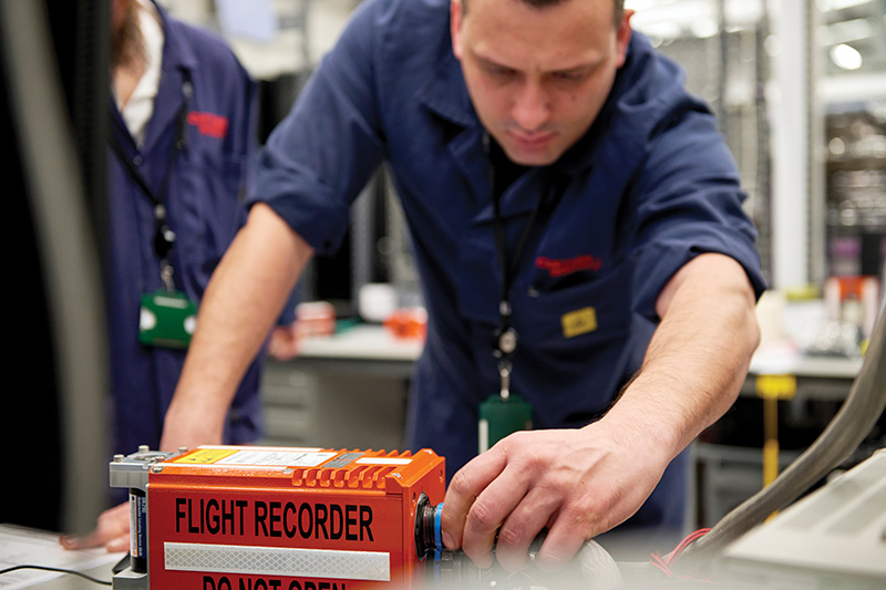 Employee operating advanced industrial equipment