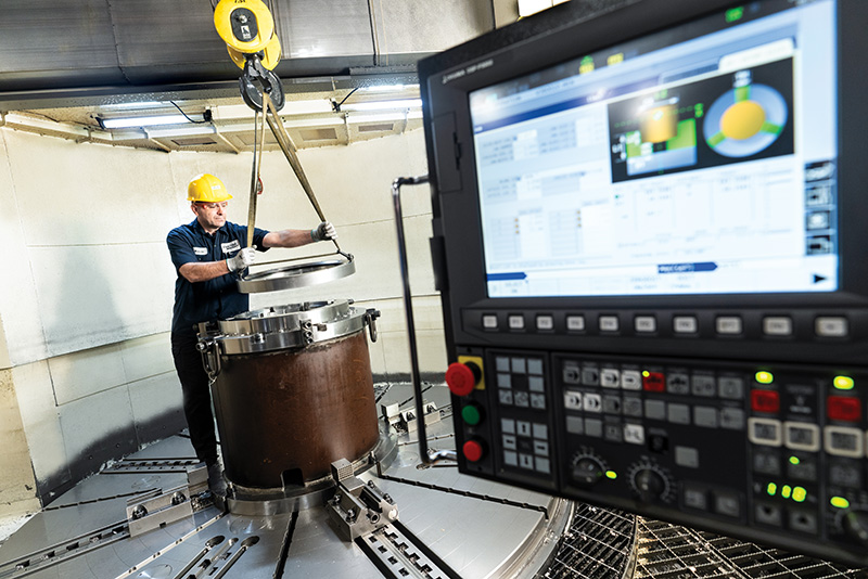 Employee operating advanced industrial equipment